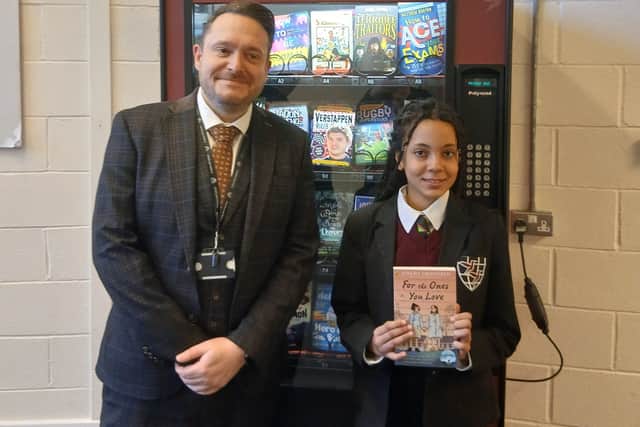 Proud student with principal Jody Clarke and first book from the vending machine