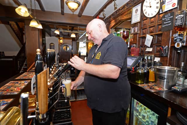 Dave Buck, manager of the Lych Gate Tavern, pulls a pint