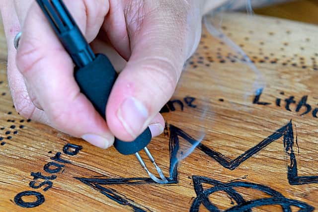 Stef burns her design onto the wood