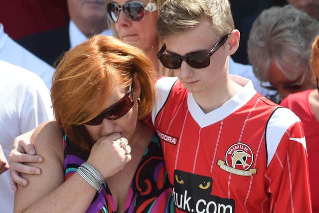 Owen comforts his mother at the Banks's Stadium days after the attack
