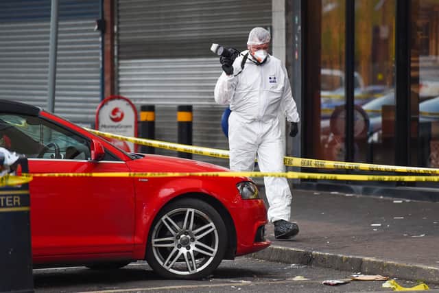 Forensic officers at the murder scene. Photo: SnapperSK