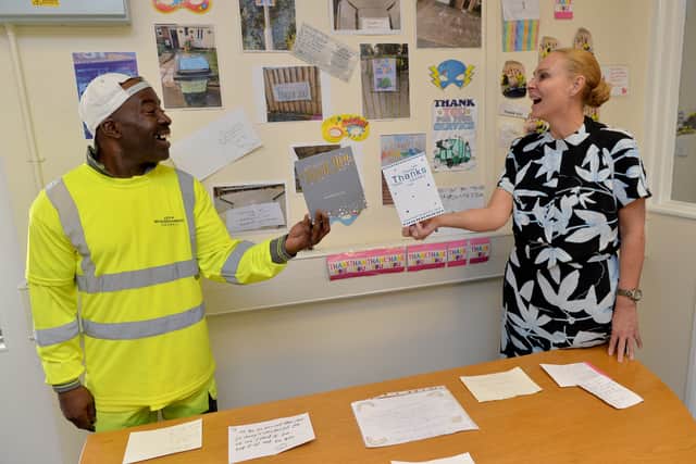 Binman Henry Wright with waste services manager Claire Demmel with the 'thank you' wall at the Hickman Ave depot with messages sent by the public for being key workers.