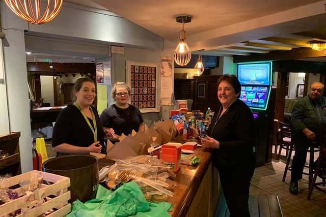 Staff at The Crown in Albrighton boxing up donations