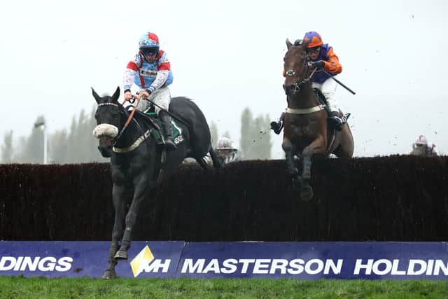 Saint Calvados ridden by Gavin Sheehan (left) clears the last before winning the Randox Health Handicap Chase during day two of The Showcase Meeting at Cheltenham Racecourse