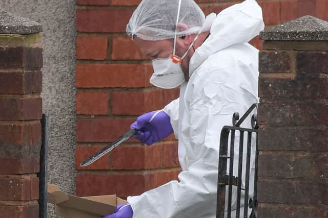 A forensic officer recovers a blade on Pensnett Road. Photo: SnapperSK