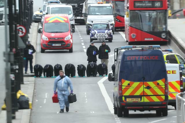 Police officers comb London Bridge for evidence after Khan's attack