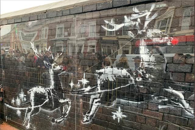 The vandalised Banksy artwork in Birmingham now protected by perspex glass. Photo from Twitter @philmackie