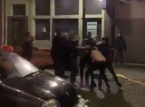 A man is attacked by a large group on Rua de Jose Falcao