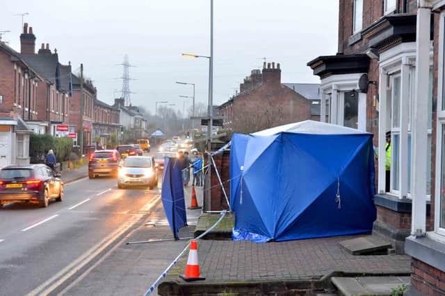 The blue tents and tape blocking the entrance to the block of flats in Stafford. Credit: Steve Leath/Express & Star