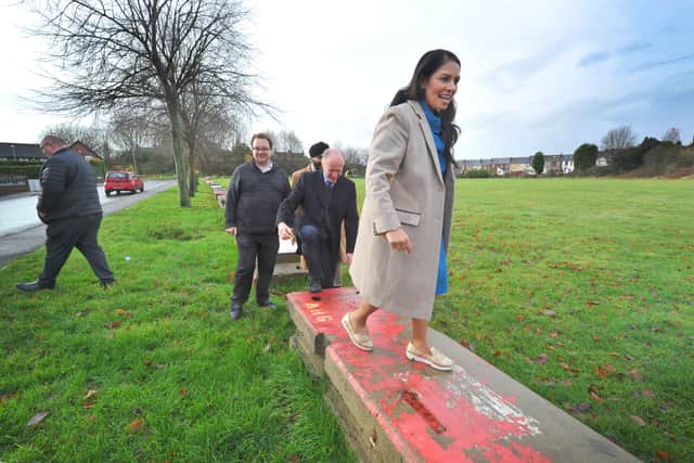 Priti Patel standing on one of the blocks in Woodside Park, Dudley.