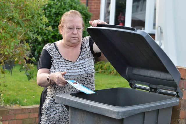 Unimpressed – Lynda Pitt puts a campaign leaflet into her wheelie bin