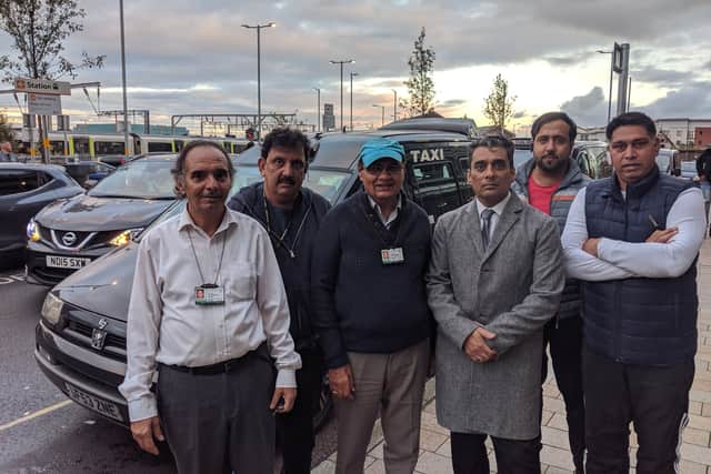 Taxi drivers and councillor Paul Singh (third from right) outside the access road of Wolverhampton train station