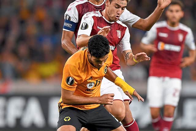 Strength: Raul Jimenez tries to hold off two Braga players (AMA/Sam Bagnall)