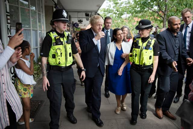 Boris Johnson and Priti Patel on a walkabout with local police officers in Harborne