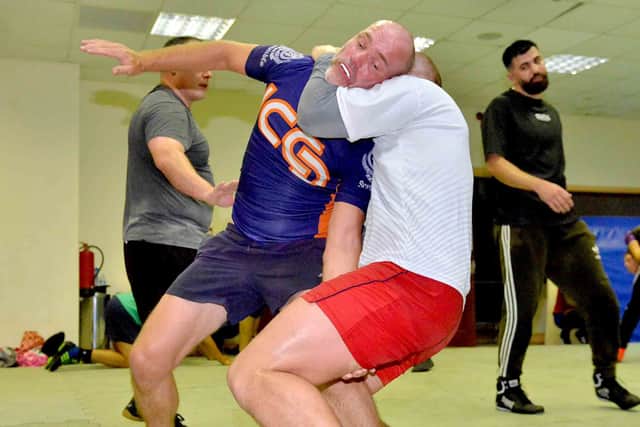 Rob Campbell is caught in a headlock by Krzystef Lewandowski