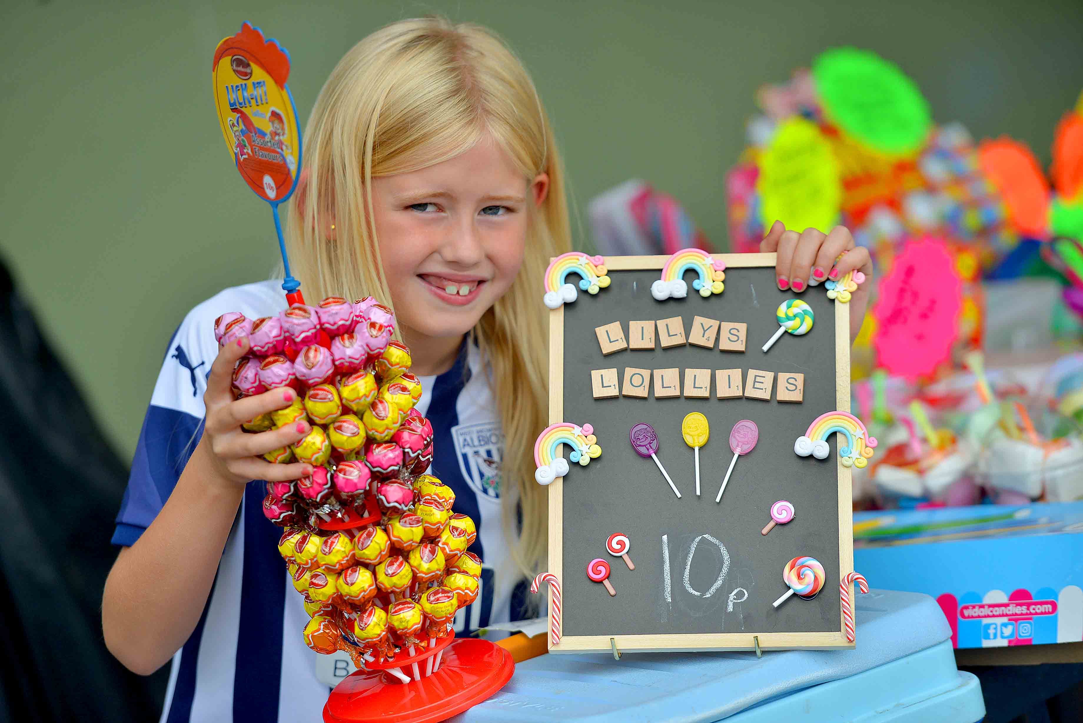 Lily Perkins, eight, with her lolly stall at Silverdale Football Club