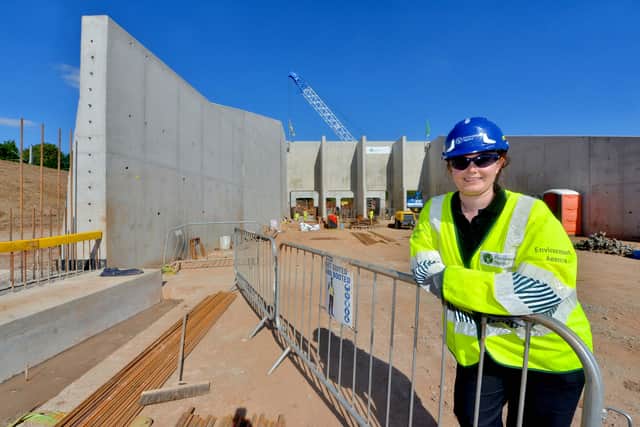 Melanie Dinnis, one of the project managers, with giant flood gates built in the usual path of the river