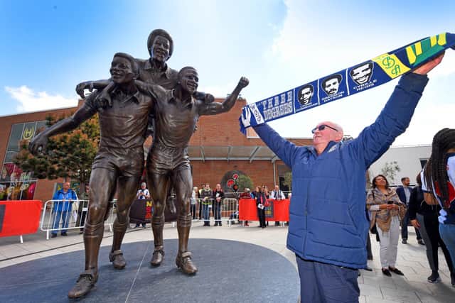 Lifelong fan Jeffrey Wat with the statue 