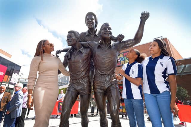 Cyrille Regis' daughter Michelle and his granddaughters Jayda, 17 and Renee, 11, take a closer look at the statue