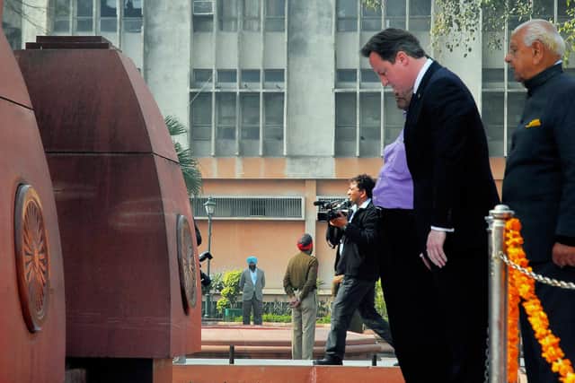 David Cameron pays his respects at the site of the massare in 2013
