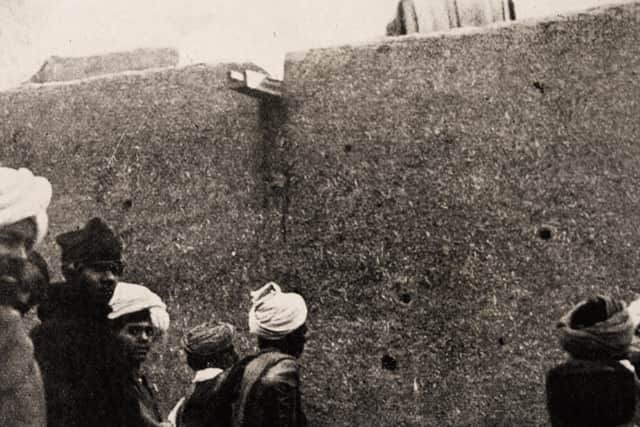 Locals inspecting bullet-holes in the southern wall, behind the shrine, in late 1919