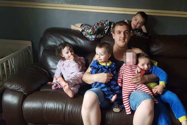Chris Moulton pictured with fire victims Tilly, Olly, Riley and Keegan. Mr Moulton and baby Jack survived