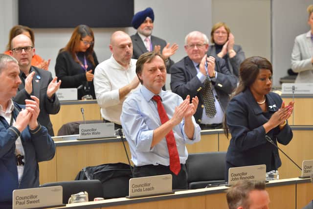 Councillors applaud after the speech