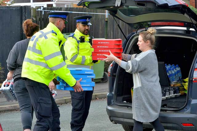 Pizza being handed out to police working on the investigation