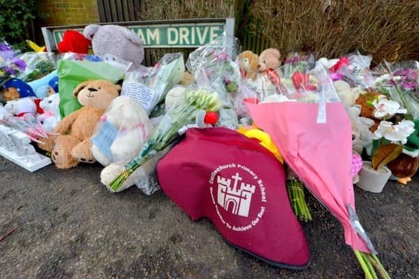 Tributes, including a Castlechurch Primary School bag, left near the scene of the fire in Highfields