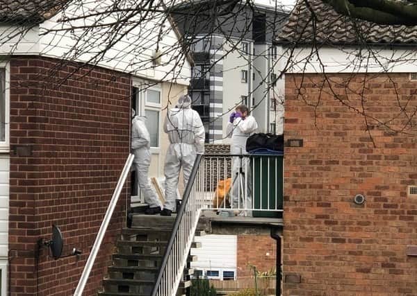 Police forensic teams at Miss Jones' flat