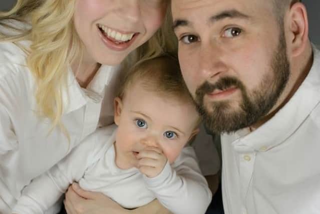 Katie Smith is all smiles as she looks forward to a family Christmas with her 18-month-old son Eli and husband Luke
