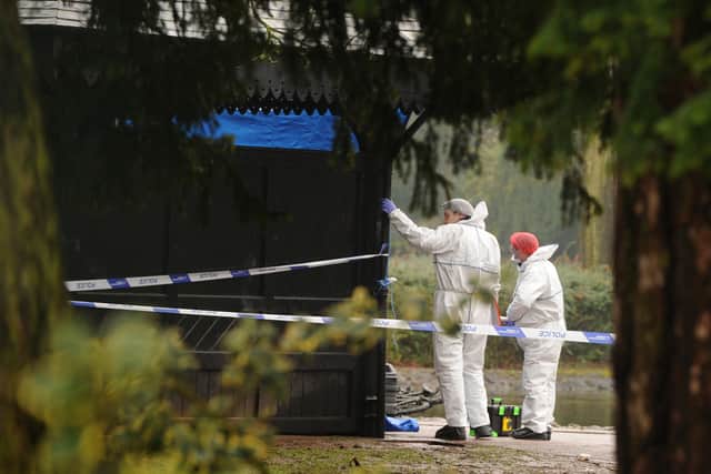 Forensic officers examine the pavilion in West Park
