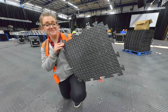 Liz Grimshaw shows one of the panels that have been used to cover the floor hall