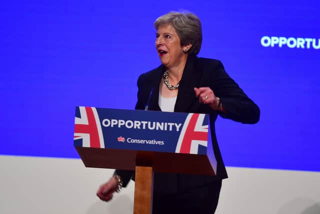 Prime Minister Theresa May dances as she arrives on stage to make her speech at the Conservative Party conference at the International Convention Centre in October