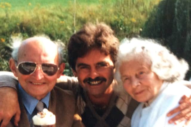 Albert, left, with his late wife Mary and son Robert, centre