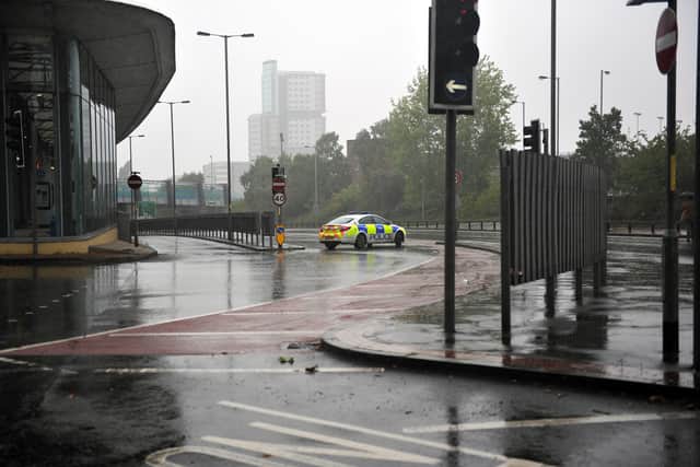 Police block off the exit to the bus station