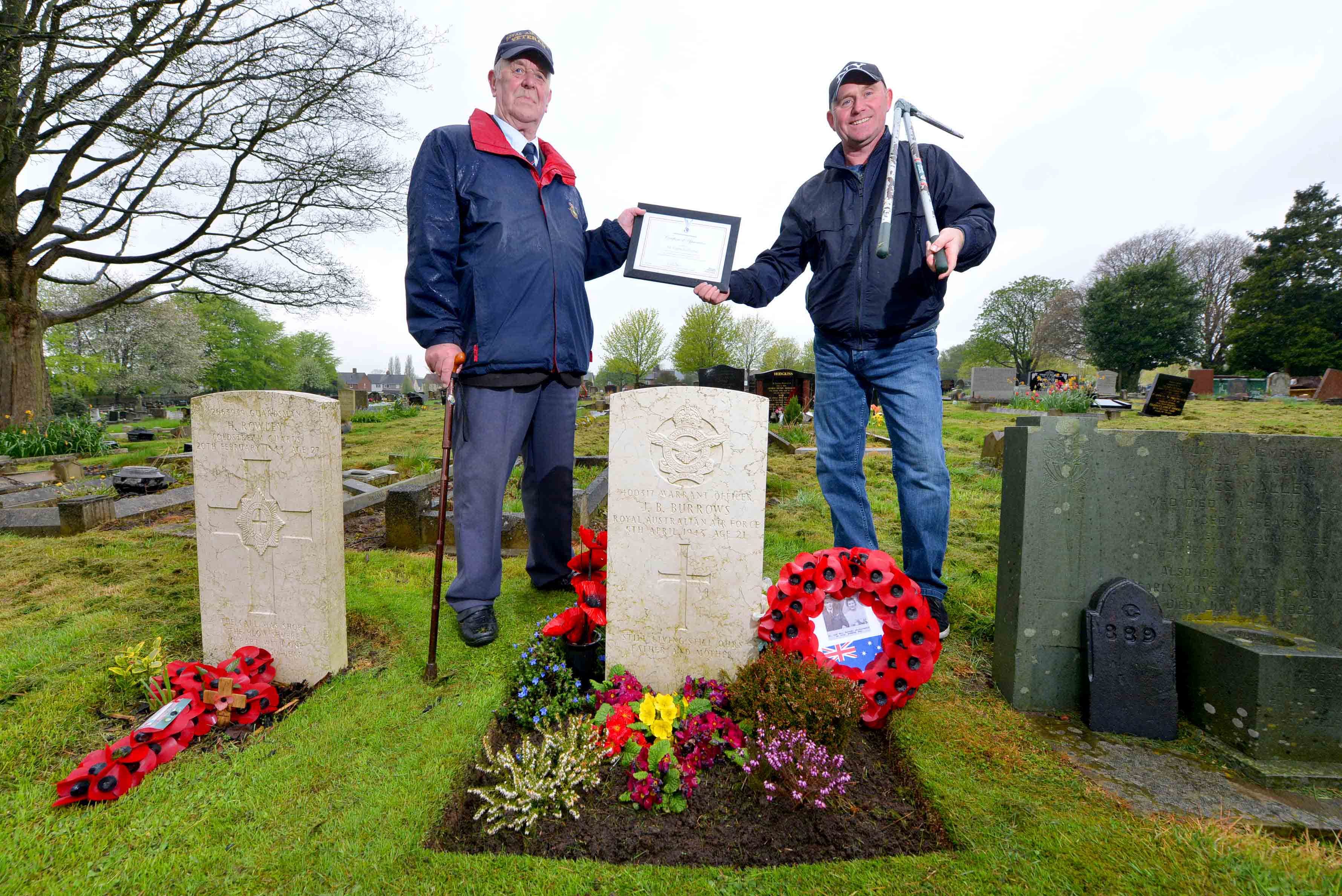 Wayne Hartshorne, 52, is presented with a certificate of appreciation by John Allman, President of Cannock Chase Royal Air Forces Association at Cannock Cemetery at the graveside of Warrant Officer John Burrows