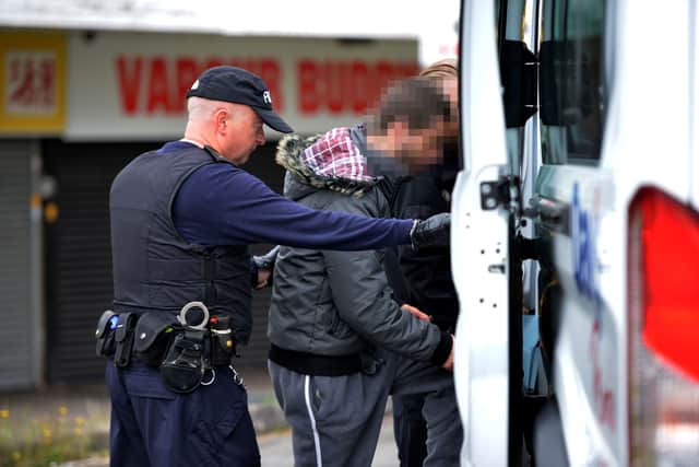 A man is taken away during the operation