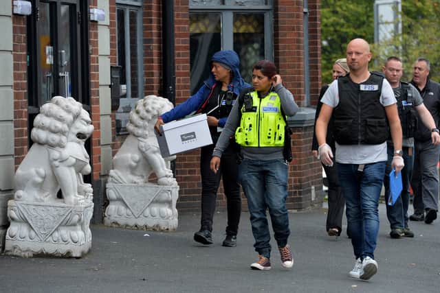 Officials arrive at the scene of the raid