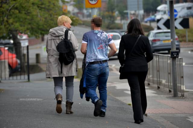 A man is led away from the scene on the Stafford Road