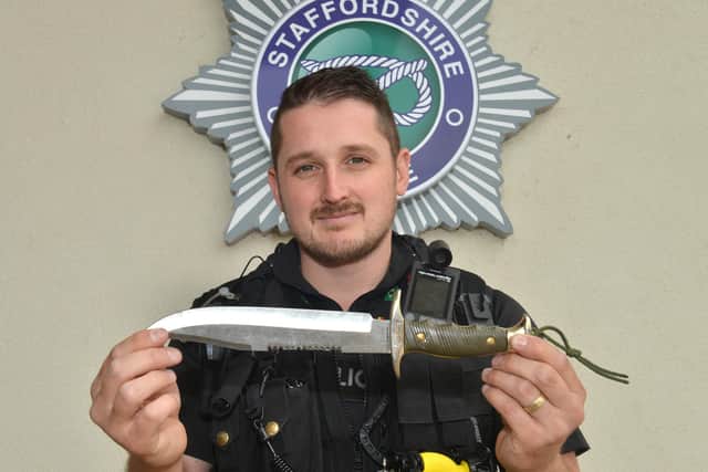 PC Paul Hamilton pictured with one of the fearsome knives handed in at last year's knife Amnesty at Staffordshire Police Headquarters in Weston Road, Stafford.