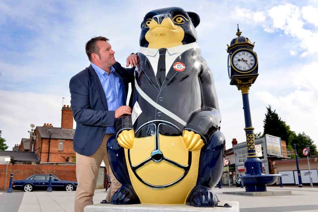 Councillor Richard Marshall with one of the bears one next to the bus station