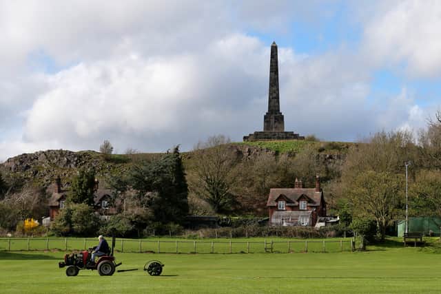 A groundsman getting the outfield ready ahead of the start of the new cricket season in Lilleshall