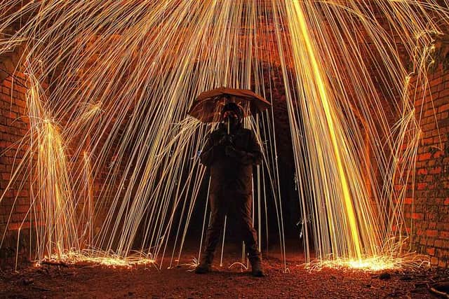 This image was taken by Stephanie Clarke and shows husband James standing under a shower of sparks