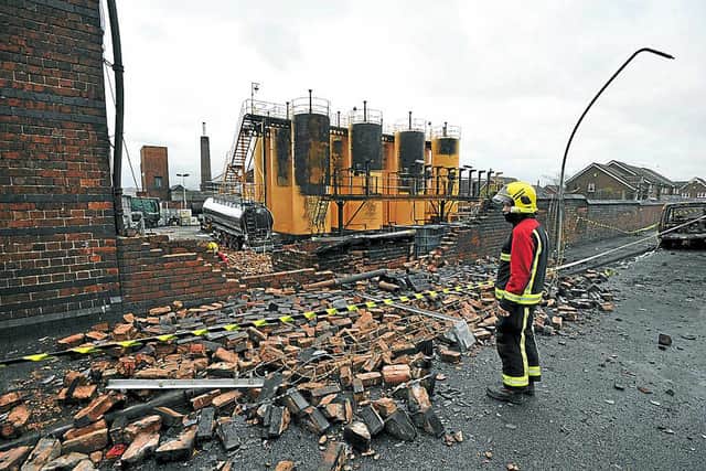 A firefighter surveys the damage