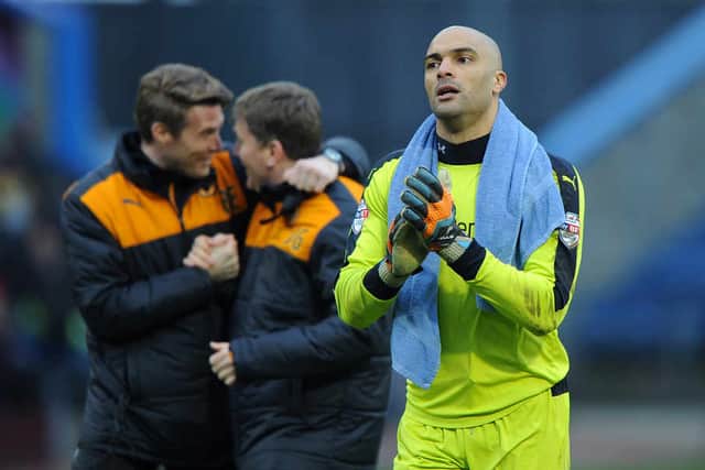 Carl Ikeme, with Rob Edwards and Joe Gallen celebrating behind him