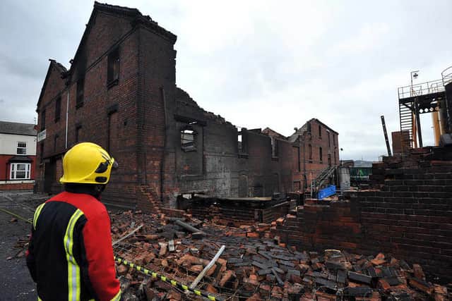 A firefighter surveys the damage