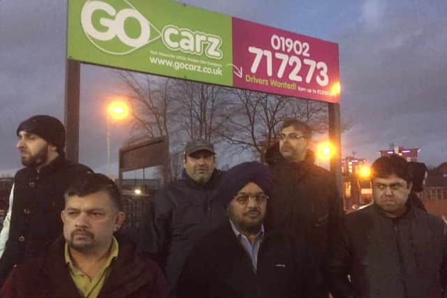Some of the protesting taxi-drivers outside the Go Carz offices