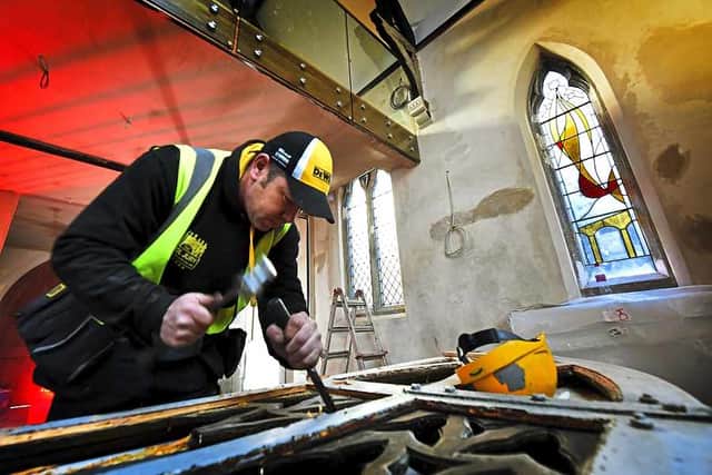 Joiner Paul Stevens working on one of the chapel doors