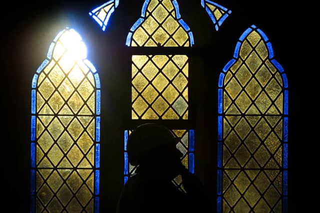 Site manager, Andy Hutchings, views one of the new windows at the restored Lye and Wollescote Cemetery Chapels, Stourbridge